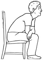 Man sitting in a chair, leaning forward.